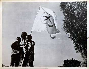 Item #16-3029 The Blessed Trinity [Poster] [African-American woman and 2 boys with radical flag]. Michael Culbertson, photographer.