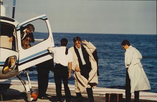 Item #16-4915 Original large format color photograph of Alain Delon getting off a helicopter at...