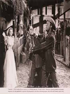 Item #17-1311 Evelyn Keyes, Glenn Ford, and Randolph Scott in “The Desperadoes”, 1943....