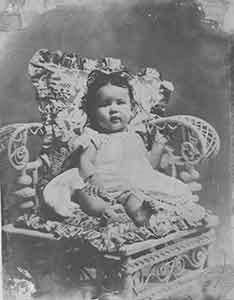 Item #19-7967 Portrait of baby sitting in chair. Unknown