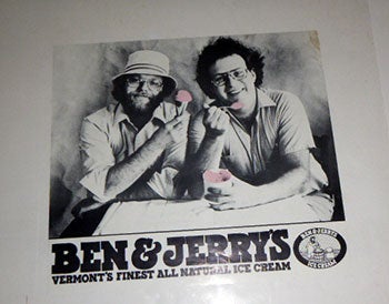 Item #51-5186 Ben & Jerry’s. Vermont's Finest All Natural Ice Cream. Ben and Jerry eating pink ice dream Original printing. Ben Cohen, Jerry Greenfield.