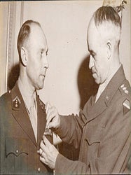 Item #51-6602 Portrait of General Omar Bradley pinning the bronze star on French colonel Jean...