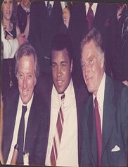 Item #51-7441 Photograph of Muhammad Ali alongside Andy William and Charlton Heston at the Victoria Club, London. John provenance Wooloughan.