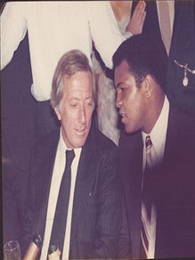 Item #51-7444 Photograph of Muhammad Ali alongside Andy Williams at the Victoria Club, London....
