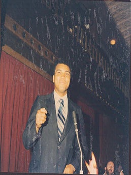 Item #51-7445 Photograph of Muhammad Ali speaking at the Victoria Club, London. John provenance...