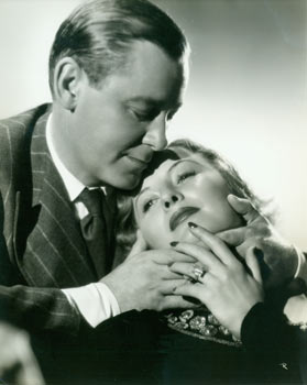 Item #63-1795 An Engagement Ring? Promotional Photograph of Barbara Stanwyck & Herbert Marshall for RKO Radio's 1937 film, Breakfast For Two. Ernest A. Bachrach, RKO Radio Pictures, phot.