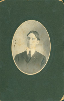 Item #63-2604 Oval Photograph of Man [Roger Blitz?] wearing a tie on a high collar, hair down the...