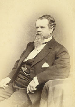 Black White Souvenir Photograph of seated bearded man wearing