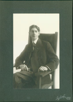 Item #63-2682 Black and White Photograph of seated man in suit wearing glasses by Frederick...