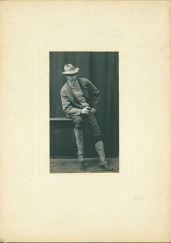 G. Layne (photographer) - Monochrome Photograph of a Man Wearing a Hat and Holding a Pipe