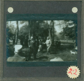 Item #63-2744 Glass Plate Negative depicting man playing fiddle in a meadow, surrounded by an audience with hands joined. 19th Century American Photographer.