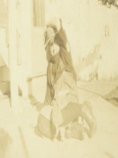 Item #63-2760 Black and white photograph of woman in suspenders and tweed hat, laying back at...