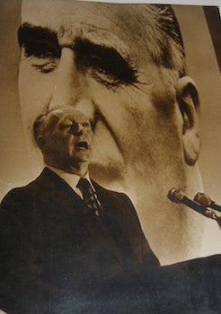 Item #63-8980 B&W Photograph of Pierre Messmer speaking before an immense portrait of President...