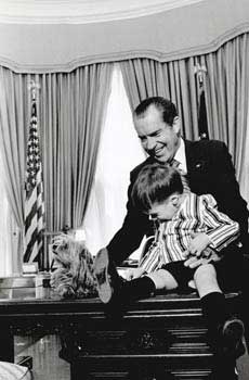 Item #70-0713 Original official White House photograph of President Richard Nixon with a child...
